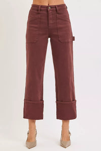 Maroon pants worn by a person on a white background