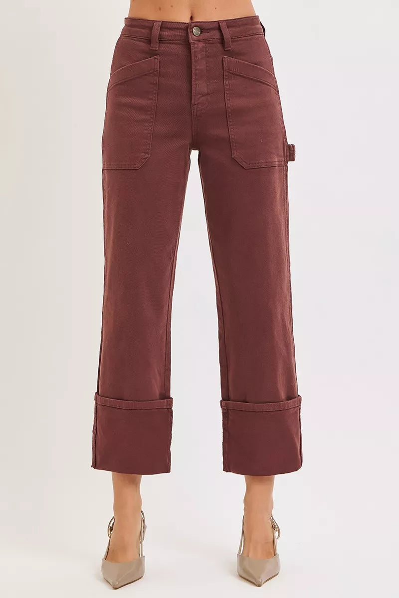 Maroon pants worn by a person on a white background