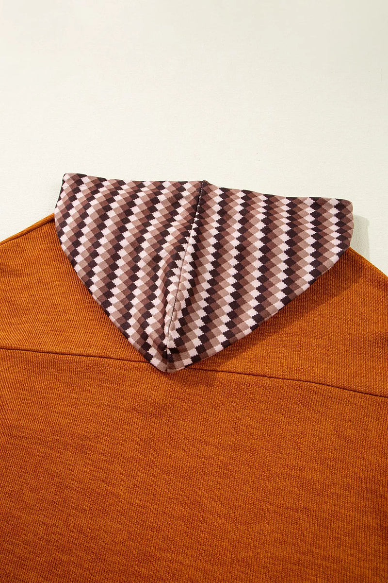 Brown sweater with a patterned collar against a white background