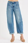 Blue jeans worn by a person on a white background