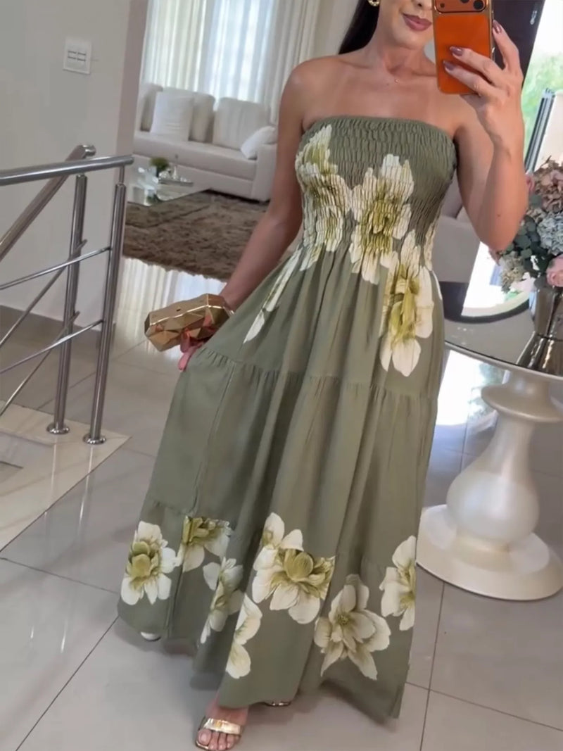 Woman wearing a strapless dress with floral patterns in a home setting.