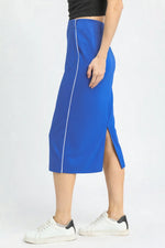 Person wearing a blue skirt with a white background