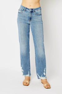 Light blue jeans with tie-dye accents on a white background
