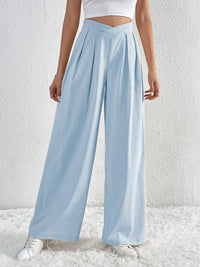 Light blue wide-leg pants worn by a person on a white background