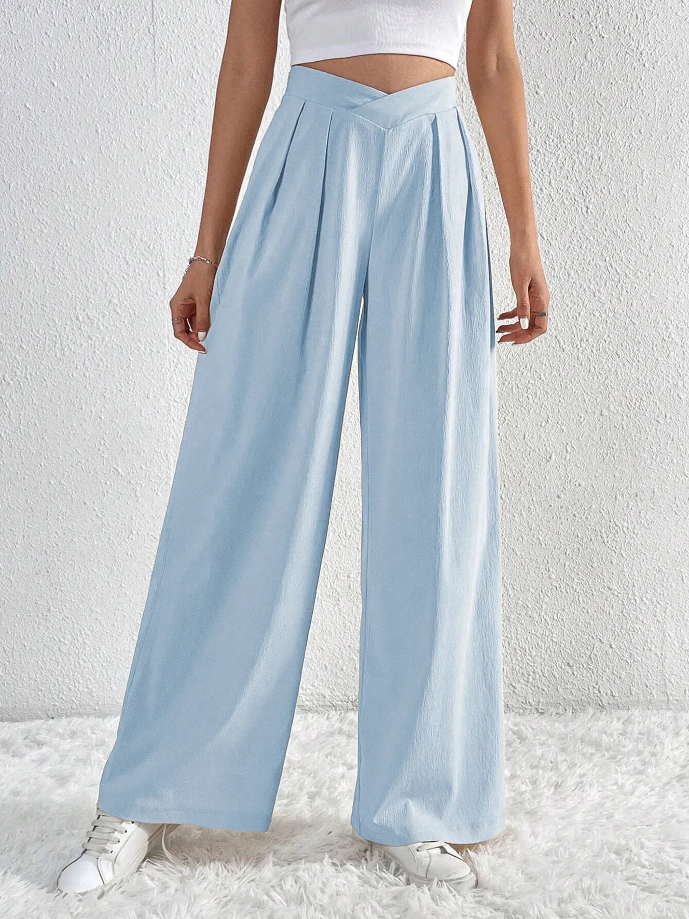 Light blue wide-leg pants worn by a person on a white background