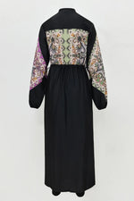 Black dress with patterned sleeves on a white background