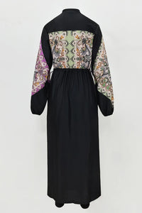 Black dress with patterned sleeves on a white background