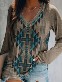 Person wearing a patterned long-sleeve shirt with a geometric design.