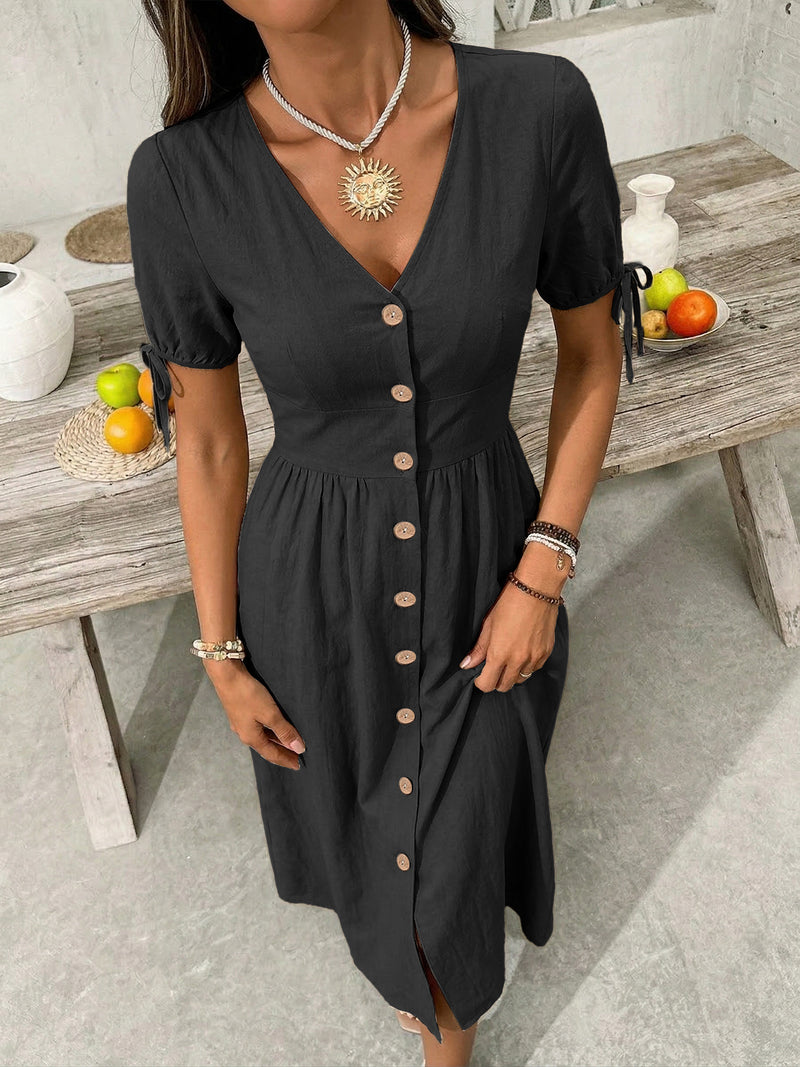 Woman wearing a black dress with buttons in a casual setting