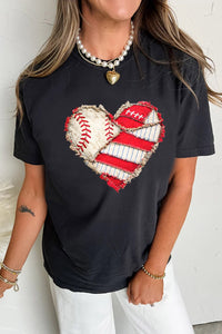 Black t-shirt with a heart design featuring a baseball and football, worn by a person.