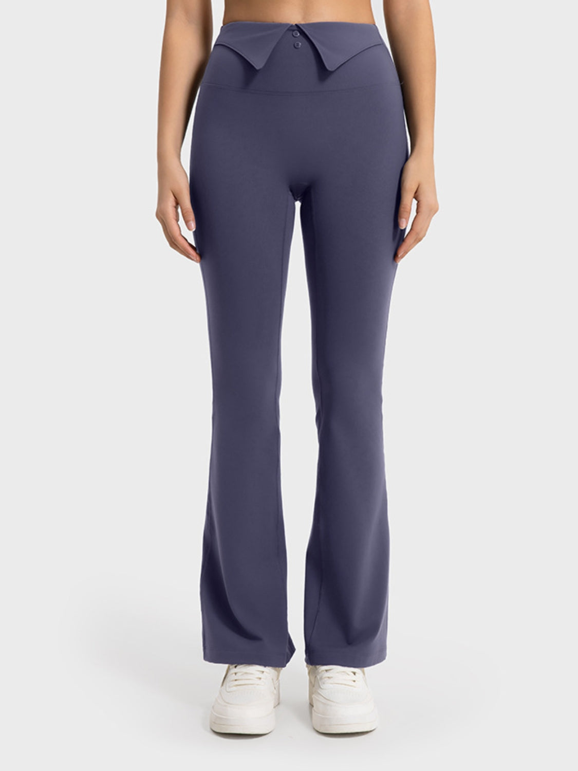 Navy blue pants worn by a person on a white background