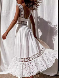 White lace dress with a flowing skirt against a white curtain background