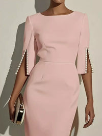 Pink dress with pearl embellishments on sleeves against a neutral background