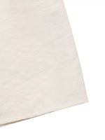 Close-up of a beige fabric texture on a white background