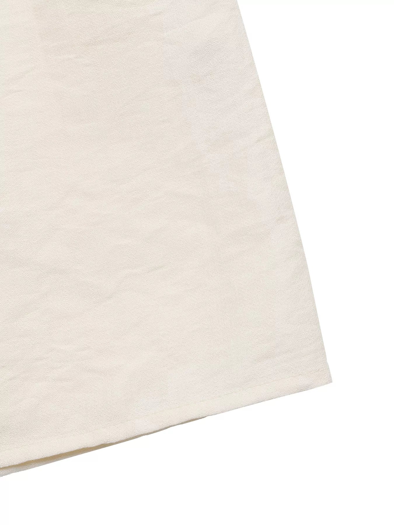 Close-up of a beige fabric texture on a white background