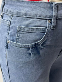 Close-up of blue denim shorts with a pocket detail.