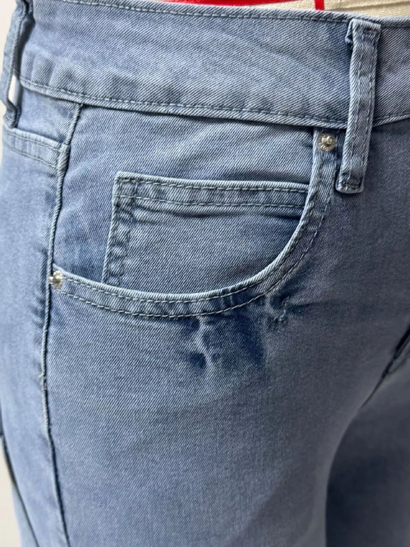 Close-up of blue denim shorts with a pocket detail.