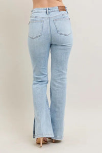 Light blue flared jeans on a beige background