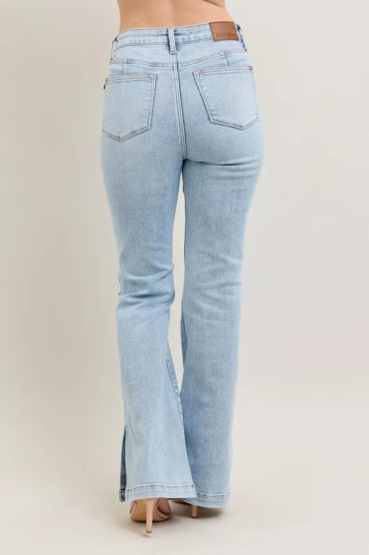 Light blue flared jeans on a beige background