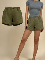 Green shorts displayed on a person against a beige background
