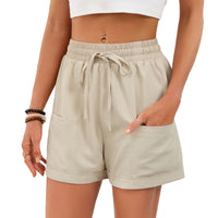 Beige shorts worn by a person on a white background