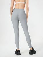 Person wearing gray leggings on a white background