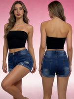 Woman wearing a black strapless top and blue denim shorts, shown from front and back on a pink background.
