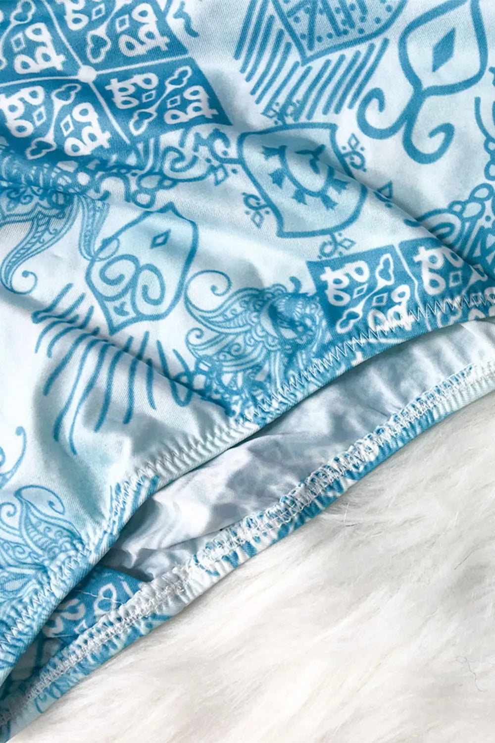 Blue and white patterned fabric on a white background