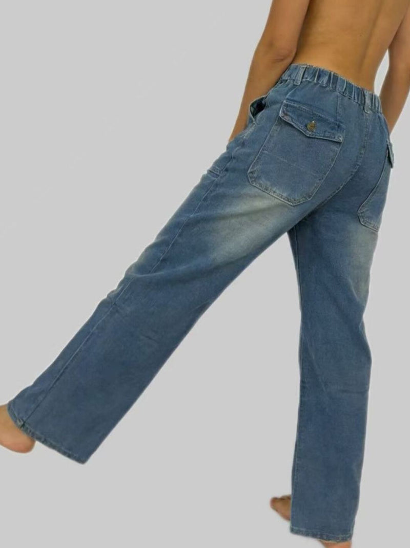 Blue jeans worn by a person on a plain background
