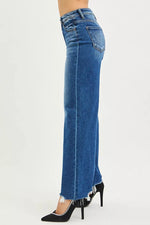 Blue jeans worn by a person on a white background
