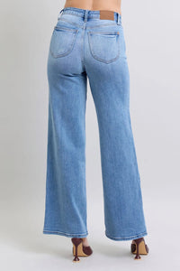 Light blue jeans worn by a person on a plain background
