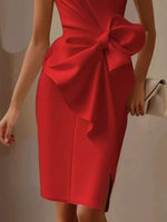 Red dress with a large bow detail on a neutral background
