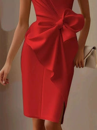 Red dress with a large bow detail on a neutral background