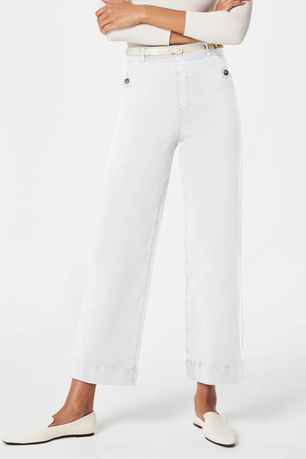 Person wearing white pants with a belt on a white background