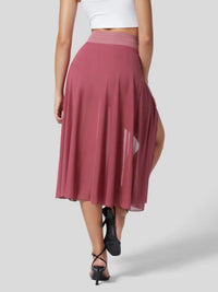 Person wearing a pink skirt with a white background