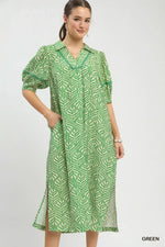 Woman wearing a green patterned dress on a white background