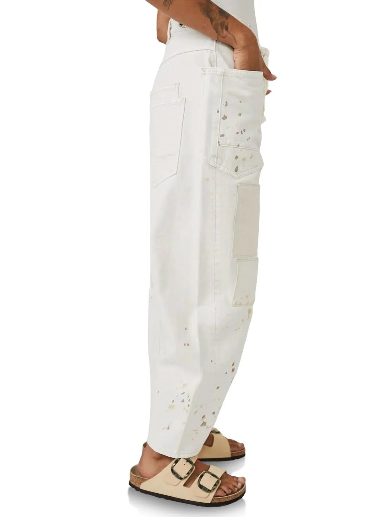 White distressed jeans worn by a person on a white background