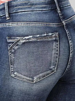 Close-up of blue jeans with a focus on the back pocket.