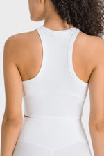 White sleeveless top worn by a person on a white background