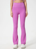 Person wearing bright pink leggings on a white background