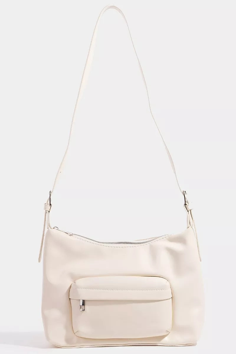 Beige handbag with a shoulder strap on a white background