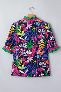 Colorful floral dress on a hanger against a gray background