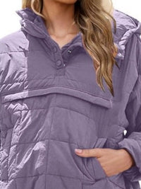 Close-up of a person wearing a purple quilted jacket with a hood.