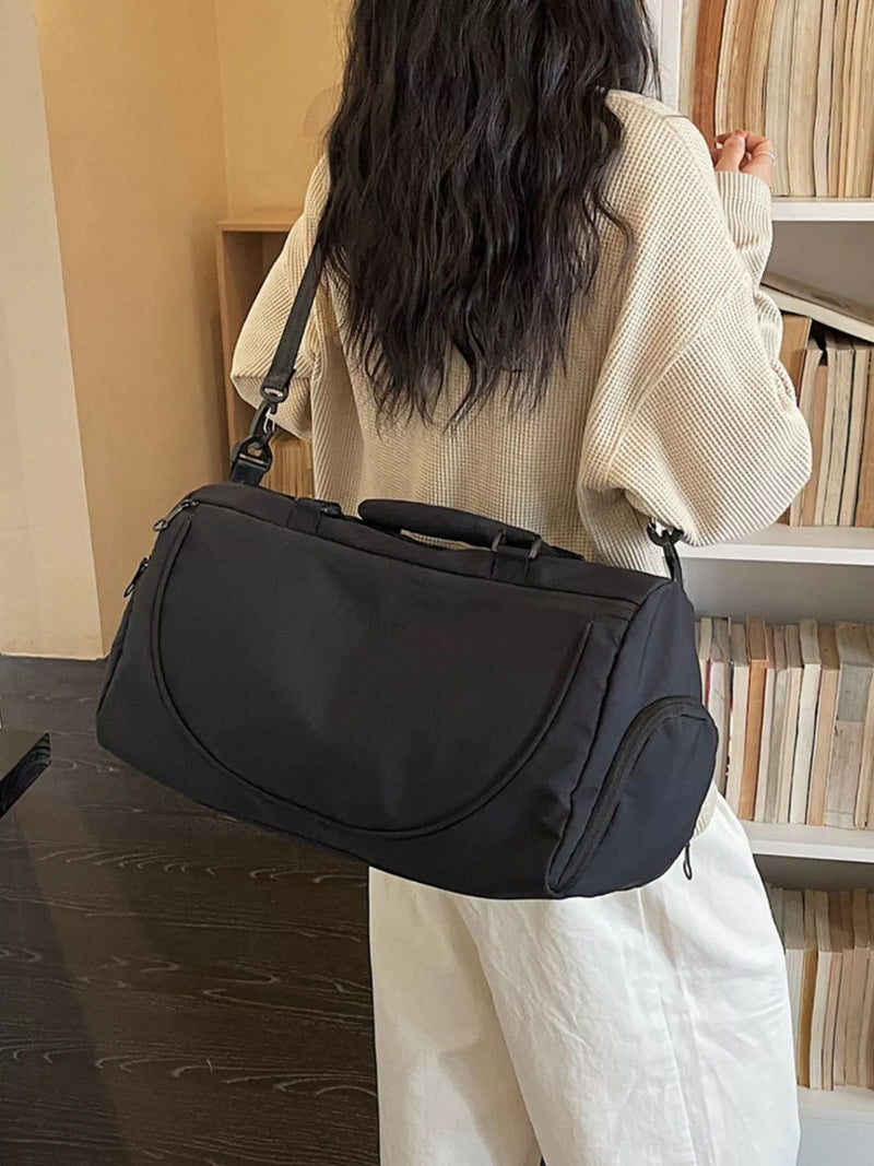 Person holding a black handbag in an indoor setting