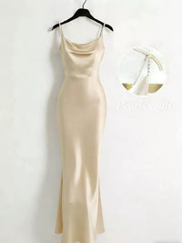 Beige slip dress on a hanger against a white background