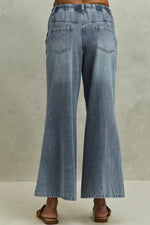 Blue denim jeans on a plain background