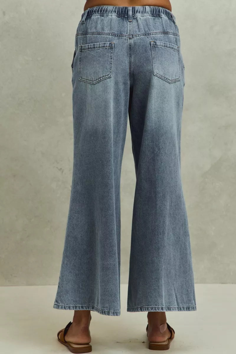 Blue denim jeans on a plain background