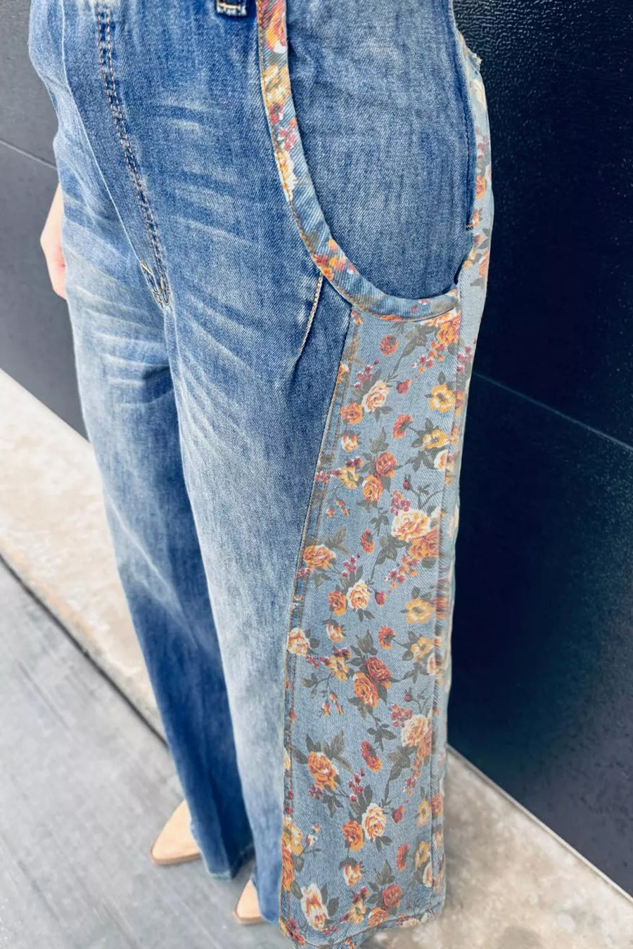Blue jeans with floral lining on a dark background