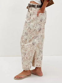 Person wearing floral pants on a white background