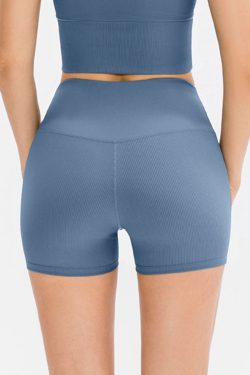 Blue athletic shorts worn by a person on a light gray background